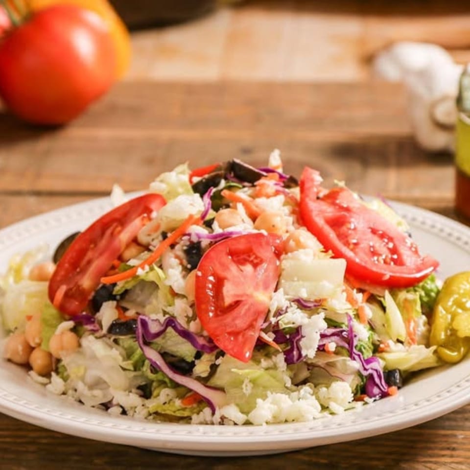 Ameci Pizza & Pasta's fresh garden salad with tomatoes, chickpeas, olives, and feta cheese.