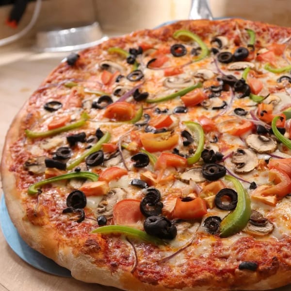 Ameci Pizza & Pasta's whole pizza with black olives, green peppers, mushrooms, and tomatoes.