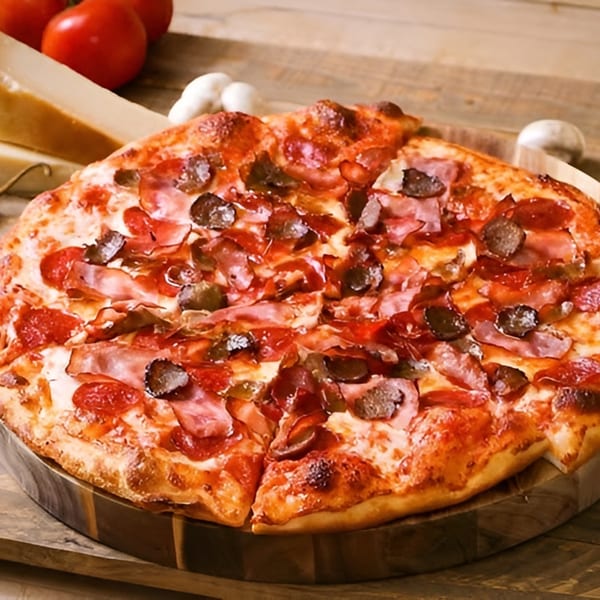 Ameci Pizza & Pasta's pepperoni, ham, and mushroom pizza on a wooden board with tomatoes and cheese.
